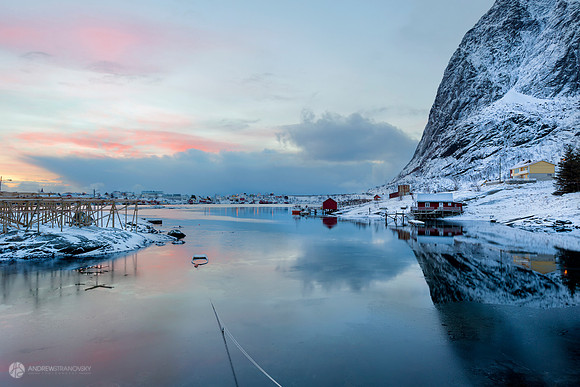 Early mornings in Reine, Lofoten Islands, Norway.  Reflections captured in a small sunken boat tied to the harbor.
